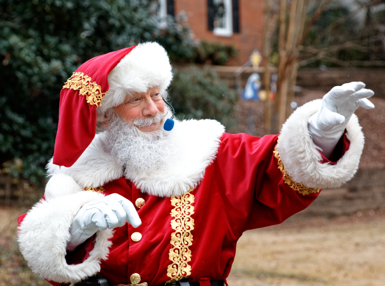 Santa Carl in his red and gold Christmas coat, welcoming visitors with open arms